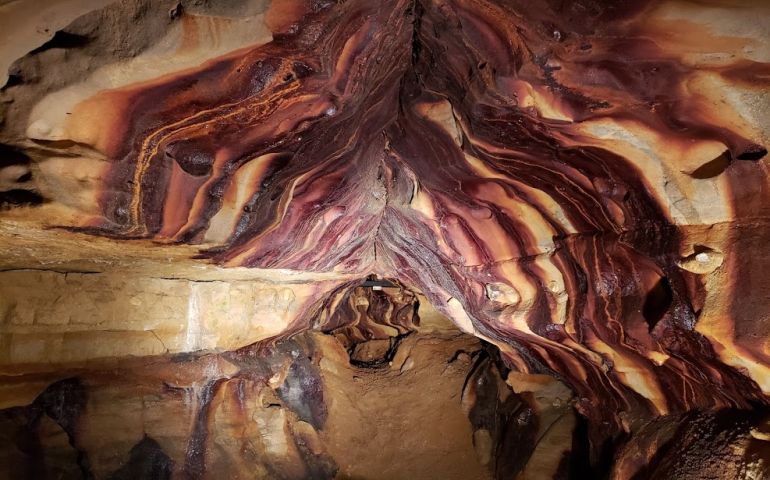A photo showing the inside of the Ohio Caverns. It has a mirrored reflection from standing water. Photo retrieved from Ohio Caverns website.