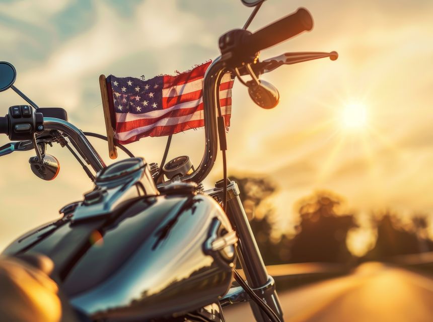 A motorcycle with an American Flag in front of it.
